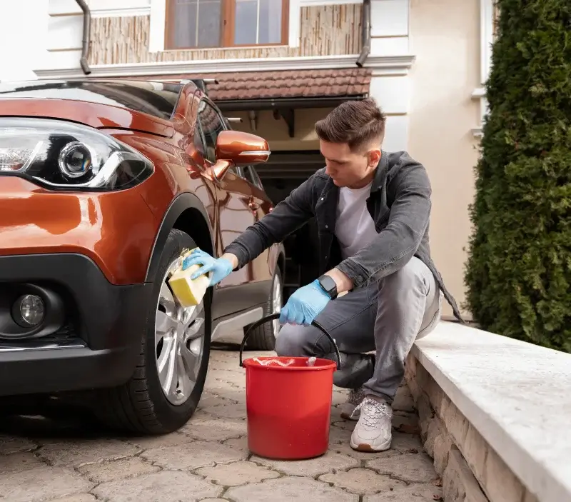 Lavage auto à domicile Neauphle-le-Vieux : professionnel intervenant sur un véhicule